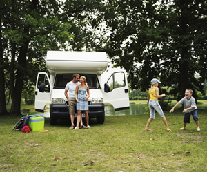 Families in front of an RV